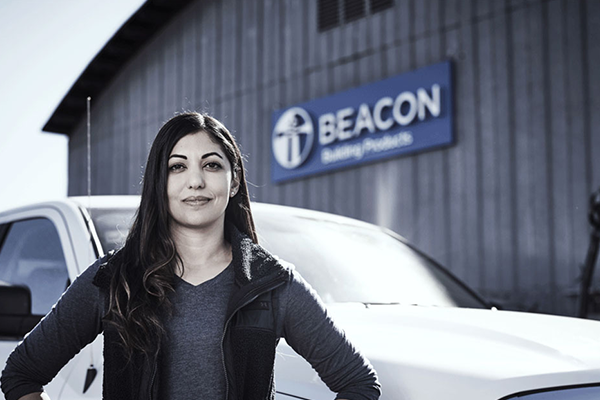 Female standing in front of a Beacon location
