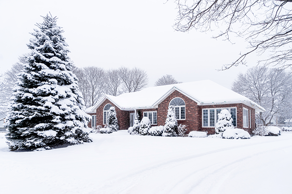 A snow-covered brick home.