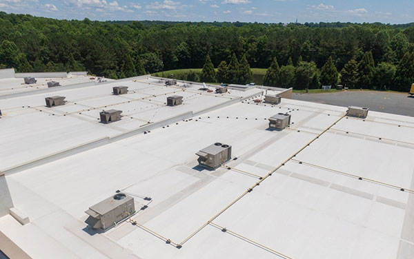 A white commercial roof ready for inspection.