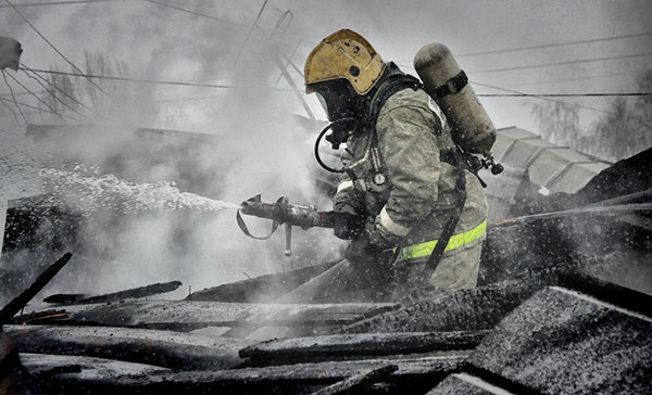 A firefighter putting out a fire.