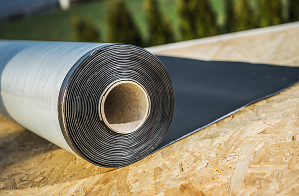 A roll of roofing underlayment on a roof.