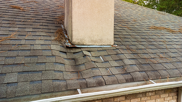 A damaged roof around a chimney.